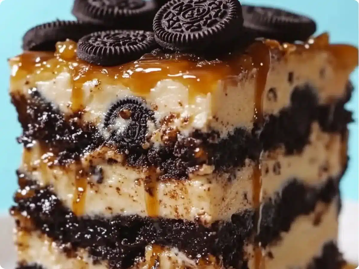 A stack of Slutty Cheesecake Bars with caramel drizzle, perfect for an indulgent dessert or party treat.